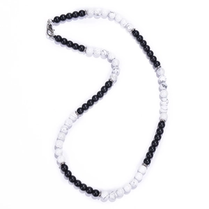 Macro detail of 6mm matte black and white map stone beaded necklace with silver spacers