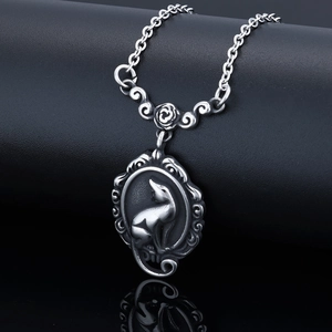Elegant vintage silver cat wreath pendant necklace displayed on a black leather stand