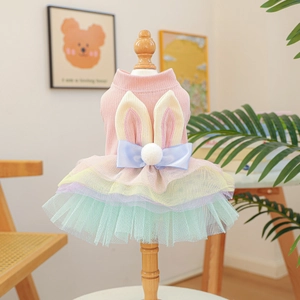 Pink rabbit-ear knit dog dress with colorful tulle tutu skirt on a mini mannequin stand