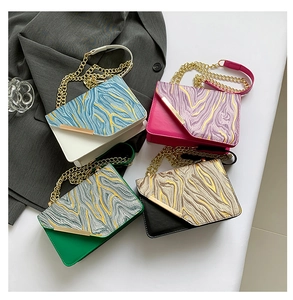 Detail of four PU leather crossbody bags with wavy texture and metal chain straps