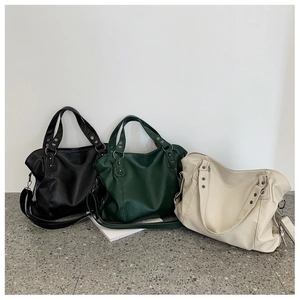 Three large minimalist leather tote bags in black, beige and dark green showing texture