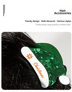 Macro view of green marble texture Christmas hat hair claw with snowflake pattern
