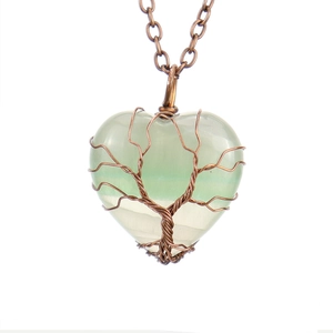 Detailed wire-wrapped bronze Tree of Life over heart-shaped green crystal pendant necklace