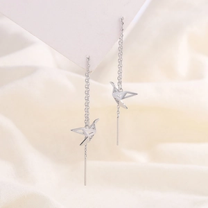 Elegant silver crane tassel earrings with sparkling crystals shown in a geometric design