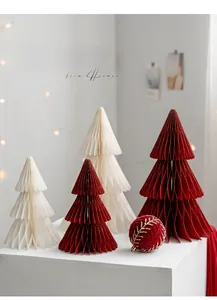 Detailed view of honeycomb paper Christmas trees and red velvet ornaments on display