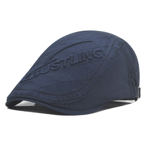 Dark blue newsboy cap with quilted diamond pattern and side embroidery in white background