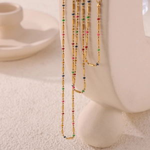 Minimalist gold titanium steel necklace set with colorful oil-drop beads on display