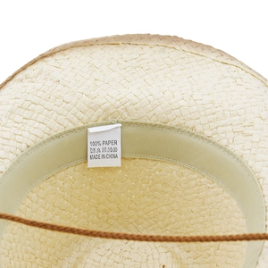 Detail view of woven paper beach hat featuring interior sweatband and adjustable cord