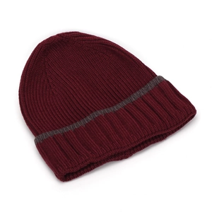 Detail of burgundy ribbed knit beanie with grey striped cuff and soft woolen texture