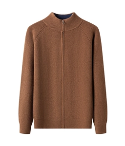 Close-up of caramel brown ribbed knit cardigan featuring a stand collar and full zipper