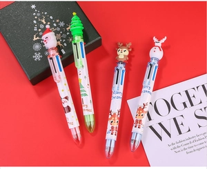 Detailed view of four Christmas multi-color ballpoint pens with festive toppers