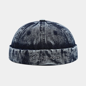 Retro washed denim brimless docker cap in dark blue with Conqueror embroidery
