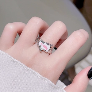Detail of irregular silver ring with pink and white enamel in a modern flowing design