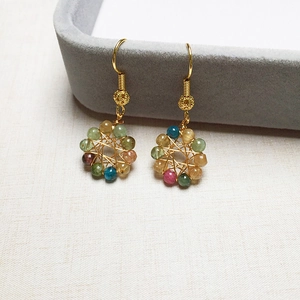 Macro shot of 14K gold-filled wire wrapped earrings with multi-colored tourmaline beads
