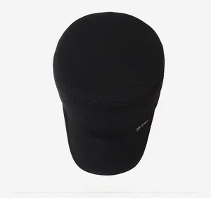 Top-down view of men's winter flat top wool cap with sport metal label and thick fabric