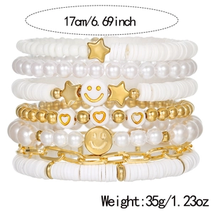 Stacked bohemian multilayer beaded bracelets with pearls, smiley faces, and star charms