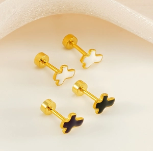 Macro detail of cross stud earrings with black and white enamel and screw back