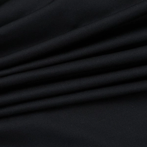 Close-up of black knitted fabric showing premium drape and smooth texture detail