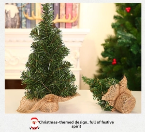 Close-up of 20cm mini artificial Christmas tree with burlap base on a festive mantle