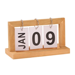 Minimalist wooden perpetual flip calendar with metal rings on a white background