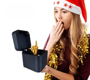 Creative prank gift box in matte black featuring a golden middle finger gesture model