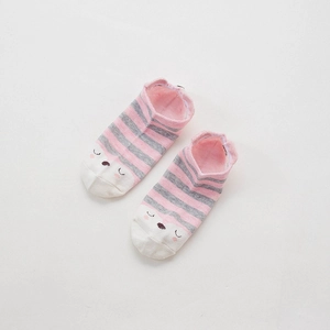 Close-up of pink and grey striped cotton socks with cute animal face patterns