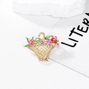 Detailed close-up of hollow flower basket brooch with colorful enamel and crystals