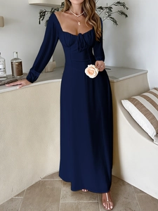 Detail of elegant navy blue square neck dress with long sleeves and waist tie