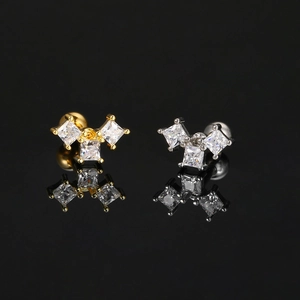 Pair of square zircon stud earrings in gold and silver finish with reflection on black