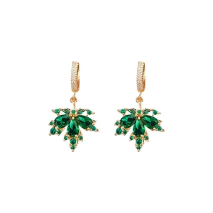 Gold plated hoop earrings with green zircon maple leaf pendant on white background