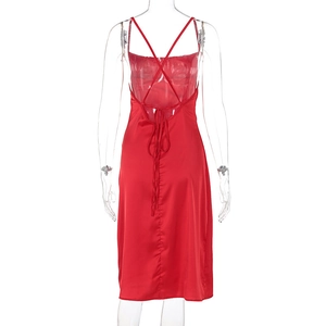 Detail of red satin backless dress featuring elegant criss-cross straps and long ties