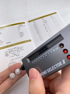 Testing 0.5ct moissanite diamond stud earrings with a professional thermal tester