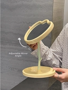 Close-up of the adjustable mirror angle on a tulip-shaped desktop makeup mirror