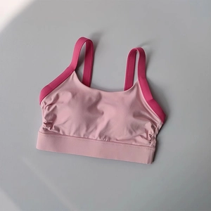 Detailed view of pink and rose red high-stretch yoga sports bra with wide underband