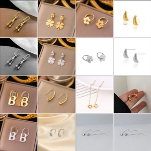 Collection of titanium steel earrings with heart, clover, and pearl tassel designs