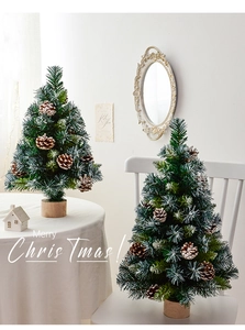 Detailed view of mini Christmas trees with pine cones, snow effects and wooden bases