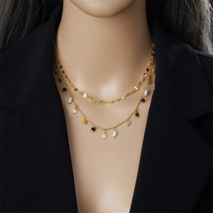 Close-up of double-layer gold necklace with star pendants and colorful beads on a model