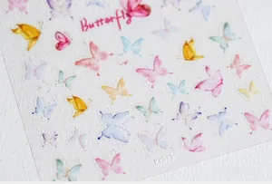 Macro detail of 5D watercolor butterfly nail art stickers with various pastel colors