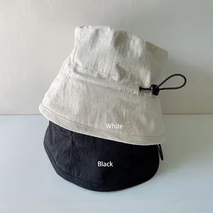 Women's summer bucket hat in black and white with adjustable drawstring cord