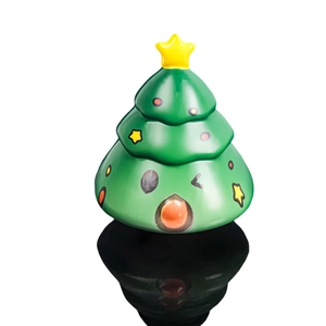 Cartoon slow rising Christmas tree squishy toy with star and cute face on black reflective base