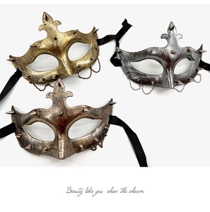 Three punk half-face masks in gold, silver, and bronze with chains and spikes on white background