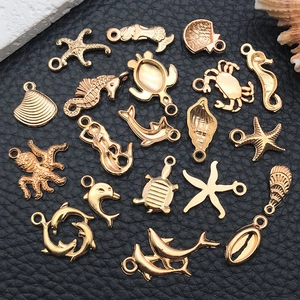Detailed view of assorted gold sea creature pendants including starfish and seahorses
