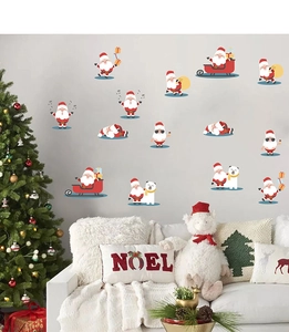 Christmas wall stickers with Santa, reindeer and polar bear motifs above a white sofa