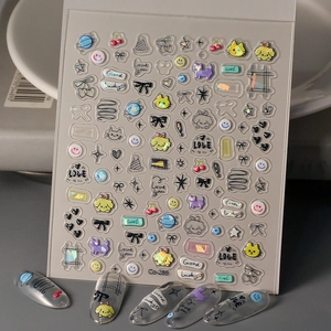Detail of 3D embossed nail stickers featuring cat, dog, and bow patterns on clear tips