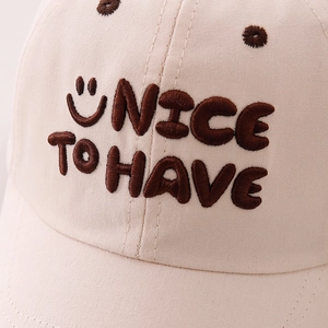 Beige cotton kids baseball cap with NICE TO HAVE smile embroidery and soft top