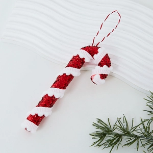 Red glitter Christmas candy cane ornament with white plush detail for tree decoration