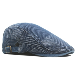 Detail view of denim patchwork ivy cap showing textured weave and copper side buckle