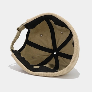 Retro corduroy docker hat in beige featuring an adjustable strap and durable lining