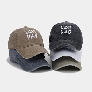 Macro shot of cotton DOG DAD baseball caps in khaki, navy, and green color options