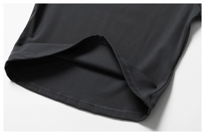 Macro shot of double-needle flatlock hem on a black brushed yoga top fabric